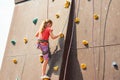 The girl on the tower of climbers conquers the peaks in an extreme park