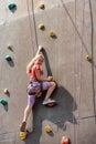 The girl on the tower of climbers conquers the peaks in an extreme park