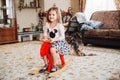 Girl on a toy horse at home Royalty Free Stock Photo