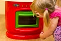 Girl and toy kitchen Royalty Free Stock Photo