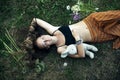 A girl with toy is lying on the green grass, a picture from above. Royalty Free Stock Photo