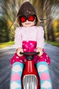 Girl on toy racing car Royalty Free Stock Photo