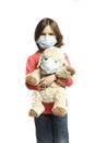 Girl with toy wearing a protective mask