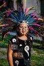 Girl with traditional customs wearing native american headdress during the annual dancing parade