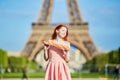 Girl with traditional French bread baguette in front of the Eiffel tower Royalty Free Stock Photo