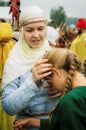 A girl in traditional Slavic costume along with his little sister in the Kaluga region of Russia.