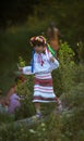 Girl in traditional Ukrainian clothes runs down the hill