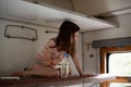 Girl in a rides in an old train. Nearby is a bottle of water Royalty Free Stock Photo