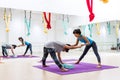 Girl trained yoga stretch closely by yoga teacher at yoga studio in Bangkok, Thailand