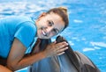 girl, trainer with dolphins Royalty Free Stock Photo