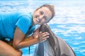 girl, trainer with dolphins Royalty Free Stock Photo