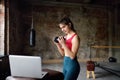Girl trainer leads online fitness class.Young woman workout by laptop. Regular sports boosts immune system and promote good health