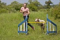 Girl training her dog to jump