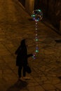 Girl with a transparent Christmas balloon with colorful leds in the old town of Palma, Majorca Royalty Free Stock Photo