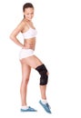 Girl with trauma of knee in brace. Royalty Free Stock Photo