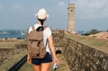 Girl traveler with a backpack and camera. Royalty Free Stock Photo