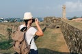 Girl traveler with a backpack and camera. Royalty Free Stock Photo