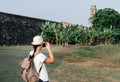 Girl traveler with a backpack and camera Royalty Free Stock Photo