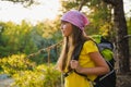 Girl traveler with backpack in hill forest. Adventure, travel, tourism concept