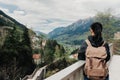 Girl traveler with a backpack is on the observation deck