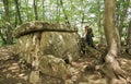 Girl traveler sits near ancient megalithic dolmen