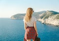 Girl traveler standing on the mountain top and looking at sea Royalty Free Stock Photo