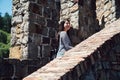 Girl traveler visiting old medieval castle walk Royalty Free Stock Photo