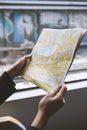 Girl with map in hand in train