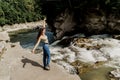 Girl is travelling in Karpathian mountains and feeling freedom. Waterfall in mountain river. Cascade waterfall and Royalty Free Stock Photo