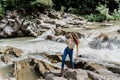 Girl is travelling in Karpathian mountains and feeling freedom. Waterfall in mountain river. Cascade waterfall and Royalty Free Stock Photo