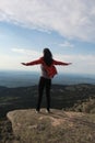 The girl travels through the mountains. Stylish hipster female traveler with a backpack. Royalty Free Stock Photo