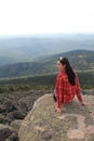 The girl travels through the mountains. Stylish hipster female traveler with a backpack. Royalty Free Stock Photo