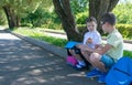 Girl treats boy apples after school in the street