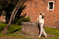 Girl tree brick stone wall well, Groot Begijnhof, Leuven, Belgium Royalty Free Stock Photo