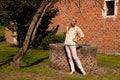 Girl tree brick stone wall well, Groot Begijnhof, Leuven, Belgium Royalty Free Stock Photo