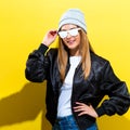 Girl in trendy painted glasses in black jacket