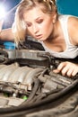 Girl tries to repair broken car