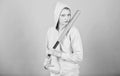 Girl troublemaker. Woman play baseball game or going to beat someone. Girl hooded jacket hold baseball bat blue