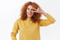 Girl trying stay positive any situation. Attractive happy redhead curly woman in yellow sweater showing peace, victory