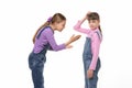 The girl is trying to explain something to her sister, she scratches her head in perplexity Royalty Free Stock Photo