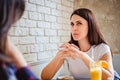 Girl trying to remember something at the cafe