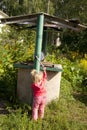 Girl trying to take water from the old well