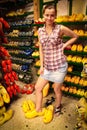 girl trying on wooden shoes in souvenir shop in Amsterdam. Caucasian young woman tourist with klompen in Holland