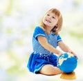 Girl turns hand globe Royalty Free Stock Photo