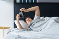 The girl turns off the annoying alarm clock to continue sleeping. Get some more sleep. It a hard morning. Time to wake up Royalty Free Stock Photo