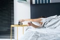 The girl turns off the annoying alarm clock to continue sleeping. Get some more sleep. It a hard morning. Time to wake up Royalty Free Stock Photo