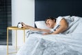 The girl turns off the annoying alarm clock to continue sleeping. Get some more sleep. It a hard morning. Time to wake up Royalty Free Stock Photo