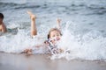 Girl in a turquoise bathing suit in the sea, happy children swimming in the sea, waves and splashes from swimming in the sea Royalty Free Stock Photo