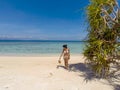 Girl on turquoise water and white beach in Camiaran island in Balabac in Philippines Royalty Free Stock Photo