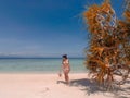 Girl on turquoise water and white beach in Camiaran island in Balabac in Philippines Royalty Free Stock Photo